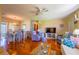 Inviting living room with hardwood floors, comfortable seating, and a large TV, perfect for relaxation and entertainment at 7437 Bass St, Englewood, FL 34224