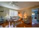 Warm living room with hardwood floors, comfortable seating, and natural light, ideal for relaxing or entertaining guests at 7437 Bass St, Englewood, FL 34224