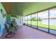 Relaxing screened patio with comfortable seating, offering a serene view of the backyard and surrounding greenery at 7437 Bass St, Englewood, FL 34224