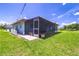 Enjoy outdoor living in this home's large screened-in porch and sunny backyard at 7437 Bass St, Englewood, FL 34224