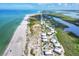 Breathtaking aerial view of the property showcasing the beach, river, and luxurious beachfront residences at 7486 Palm Island Dr # 2413, Boca Grande, FL 33921