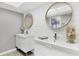 Modern bathroom featuring dual vanities, stylish mirrors, and unique patterned flooring at 7486 Palm Island Dr # 2413, Boca Grande, FL 33921