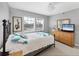 Bright bedroom features light walls, carpet, and dresser with flatscreen television at 7486 Palm Island Dr # 2413, Boca Grande, FL 33921