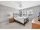 Comfortable bedroom with ample natural light from the double windows, light grey walls, and carpeted floors at 7486 Palm Island Dr # 2413, Boca Grande, FL 33921