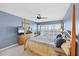 Comfortable bedroom with a four-poster bed, ceiling fan, and scenic views from the windows at 7486 Palm Island Dr # 2413, Boca Grande, FL 33921