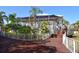 Exterior of the community clubhouse with stairs and inviting front porch at 7486 Palm Island Dr # 2413, Boca Grande, FL 33921