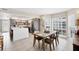 Inviting dining area with a rustic wood table and chairs adjacent to a bright, modern kitchen at 7486 Palm Island Dr # 2413, Boca Grande, FL 33921