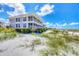 Beautiful beachfront condo building with balconies and large windows, set amidst natural dunes and vegetation at 7486 Palm Island Dr # 2413, Boca Grande, FL 33921