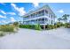 Stunning beachfront condo showcasing multi-story design with ample balcony space and white picket railings at 7486 Palm Island Dr # 2413, Boca Grande, FL 33921