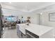 Bright kitchen with a farm sink and stainless steel appliances, seamlessly flowing into the dining and living area at 7486 Palm Island Dr # 2413, Boca Grande, FL 33921