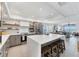An open kitchen concept featuring a white island, stainless steel appliances, and connection to the living area and ocean views at 7486 Palm Island Dr # 2413, Boca Grande, FL 33921