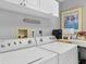 Functional laundry room with white cabinets and modern washer and dryer at 7486 Palm Island Dr # 2413, Boca Grande, FL 33921
