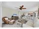 Inviting living room featuring comfortable seating, a ceiling fan, and views into an open kitchen at 7486 Palm Island Dr # 2413, Boca Grande, FL 33921