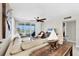 Bright living room featuring comfortable sofas, tile flooring, and sliding doors leading to the balcony with beach views at 7486 Palm Island Dr # 2413, Boca Grande, FL 33921