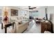 Bright and airy living room with comfortable seating, tile floors, and sliding doors leading to the balcony at 7486 Palm Island Dr # 2413, Boca Grande, FL 33921