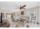 Bright living room features comfortable sofas, a ceiling fan, and an open layout into the kitchen and dining area at 7486 Palm Island Dr # 2413, Boca Grande, FL 33921
