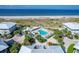 Aerial view of community pool and buildings highlighting beautiful landscape with a tranquil beach view in the background at 7486 Palm Island Dr # 2413, Boca Grande, FL 33921