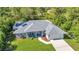 Aerial view of a well-maintained home featuring a manicured lawn and lush landscaping at 7933 Minardi St, North Port, FL 34291