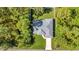 Aerial view of a well-maintained single-Gathering home with a long driveway and mature trees on a spacious lot at 7933 Minardi St, North Port, FL 34291