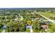 Overhead shot of single Gathering home nestled among lush green trees and lawns in a quiet residential neighborhood at 7933 Minardi St, North Port, FL 34291