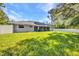 Large backyard with a lush green lawn and a white fence, perfect for privacy and recreation at 7933 Minardi St, North Port, FL 34291
