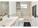 Bright bathroom with a tub shower combo and sink at 7933 Minardi St, North Port, FL 34291
