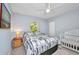 Comfortable bedroom with a large bed, crib and soft carpet at 7933 Minardi St, North Port, FL 34291
