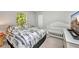 Comfortable bedroom with a large bed, crib and soft carpet at 7933 Minardi St, North Port, FL 34291