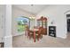 This dining room has natural light, traditional wooden furniture, and carpet flooring at 7933 Minardi St, North Port, FL 34291