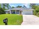 Charming single-story home with a well-manicured lawn and a two-car garage at 7933 Minardi St, North Port, FL 34291