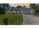 Charming one-story home with a well-manicured lawn, inviting front entrance, and an attached two car garage at 7933 Minardi St, North Port, FL 34291