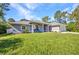 Beautiful single-story home with a well-maintained lawn, American flag, and charming front porch at 7933 Minardi St, North Port, FL 34291