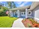 A home's front porch features a walkway, flower garden, and seating at 7933 Minardi St, North Port, FL 34291