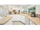 Bright kitchen features white cabinetry, light countertops, stainless steel appliances and ample counter space at 7933 Minardi St, North Port, FL 34291