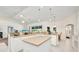 Spacious kitchen boasts white cabinets, an island, stainless steel appliances, and easy access to dining area at 7933 Minardi St, North Port, FL 34291