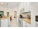 Modern kitchen features stainless steel appliances, white cabinets, and tiled floors at 7933 Minardi St, North Port, FL 34291