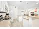 Bright open kitchen with white cabinets, an island, and stainless steel appliances offers convenient access to dining at 7933 Minardi St, North Port, FL 34291