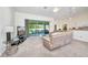 Bright, spacious living room with a sliding glass door to the backyard and modern furniture at 7933 Minardi St, North Port, FL 34291