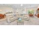 Open floor plan with a spacious living room connected to a dining area and kitchen at 7933 Minardi St, North Port, FL 34291
