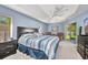 Spacious main bedroom with a ceiling fan, a walk-in closet, and a sliding glass door to the yard at 7933 Minardi St, North Port, FL 34291