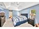 Large main bedroom features a ceiling fan, a sliding glass door, and an ensuite bathroom at 7933 Minardi St, North Port, FL 34291