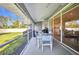 Inviting screened patio features an outdoor dining area with views of the backyard at 7933 Minardi St, North Port, FL 34291