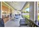 Relaxing screened-in patio with ceiling fans and comfortable seating, perfect for enjoying the outdoors at 7933 Minardi St, North Port, FL 34291