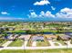 Beautiful aerial view of home with lush landscaping and waterfront access under a partly cloudy sky at 926 Boundary Blvd, Rotonda West, FL 33947