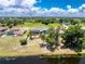 Aerial view shows a property with mature landscaping, waterfront, and surrounding neighborhood at 926 Boundary Blvd, Rotonda West, FL 33947