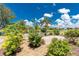 Lush backyard with manicured landscaping, brick patio, and scenic water view at 926 Boundary Blvd, Rotonda West, FL 33947