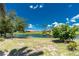 Spacious waterfront backyard with mature trees and expansive lawn at 926 Boundary Blvd, Rotonda West, FL 33947