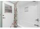 Bathroom featuring a shower with a decorative curtain, a bathtub and white tile walls at 926 Boundary Blvd, Rotonda West, FL 33947