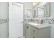 Bathroom featuring granite countertops, decorative wall tiles, and a well-lit mirror above the sink at 926 Boundary Blvd, Rotonda West, FL 33947