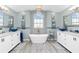 Spa-like bathroom featuring dual vanities, a freestanding tub, and decorative accents for a luxurious experience at 926 Boundary Blvd, Rotonda West, FL 33947